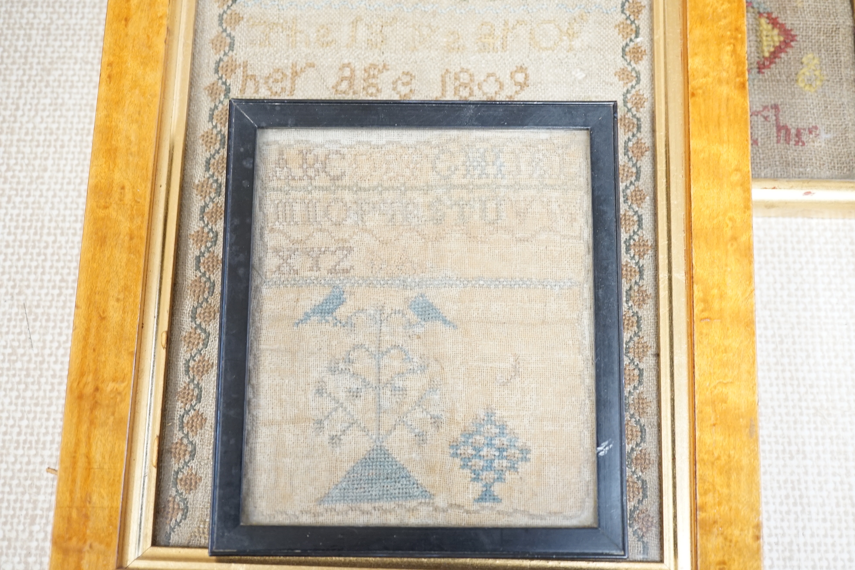Five various Victorian needlework samplers, and another, 1927, largest 41cm wide x 46cm high